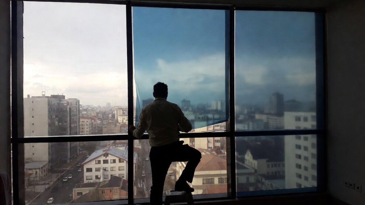 person installing commercial window film image