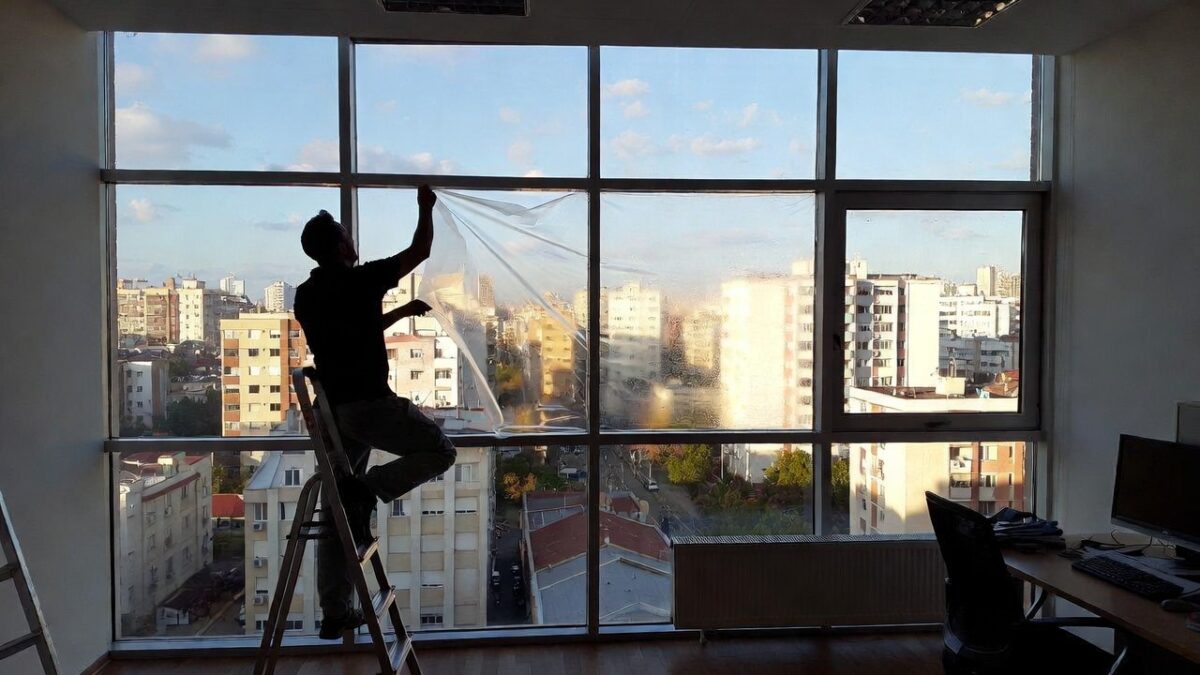 person removing window film image